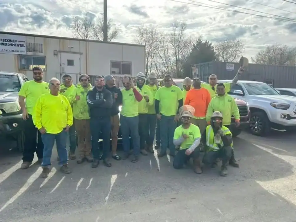 The Total Wrecking crew in hi-vis shirts in front of the site trailer at McKee Run in Dover, Delaware